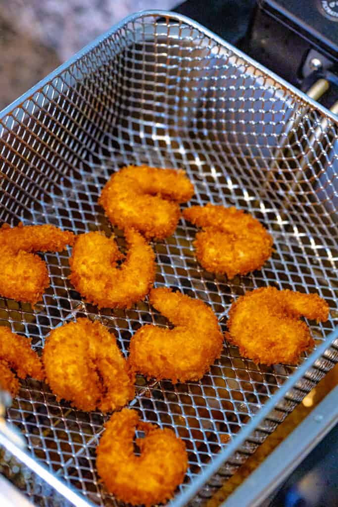 Fry shrimp in batches for 2-3 minutes until golden brown and internal temperature reaches 165F.