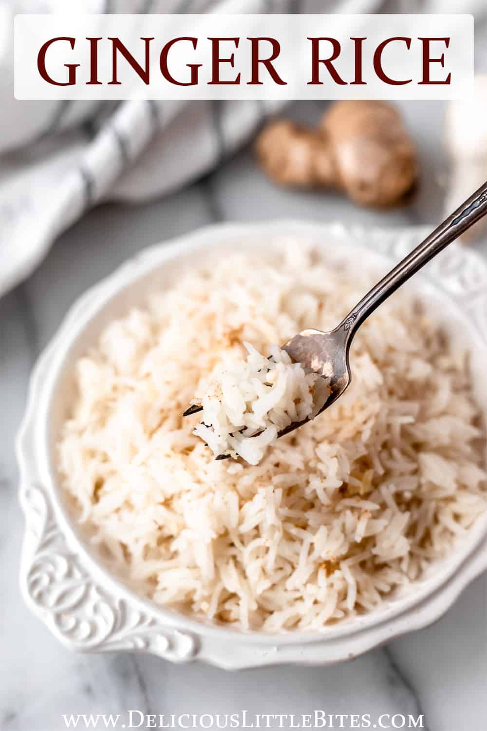 Ginger rice on a fork held up in front of a white bowl of rice with a striped towel and ginger in the background with text overlay.