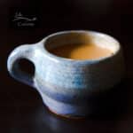 square crop of a blue mug filled with chai tea.