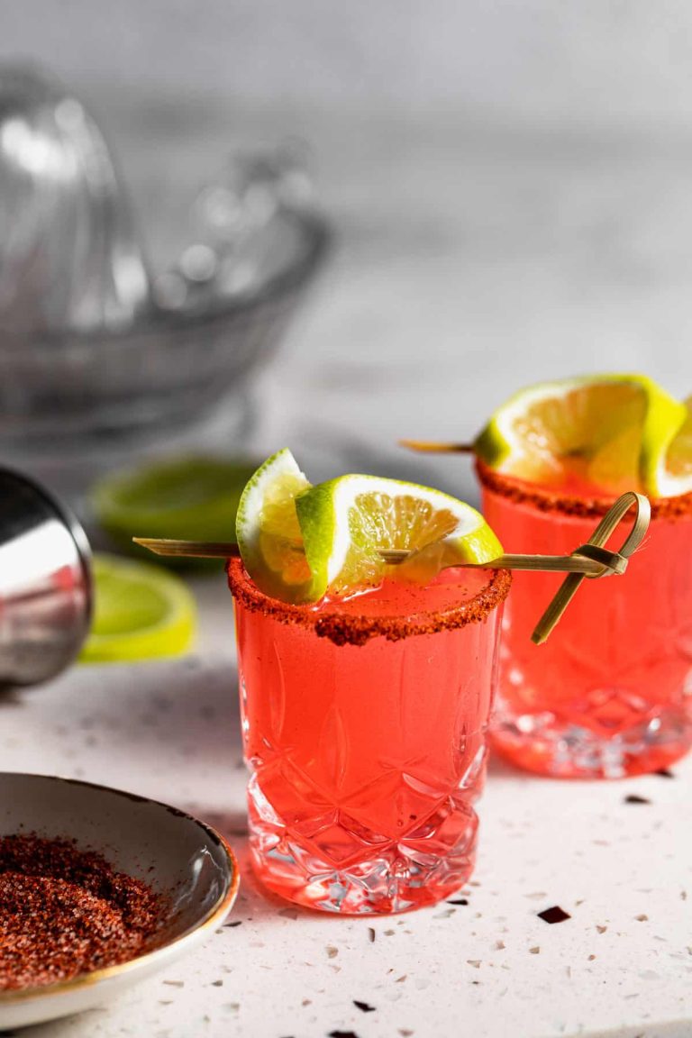 Two Mexican Candy Shots on a white background with a lime garnish.